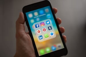 An iPhone displaying icons for popular social media channels that are ideal for video marketing distribution.